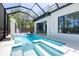 Stunning pool with waterfall feature, and surrounding screened enclosure at 2375 Floyd St, Sarasota, FL 34239