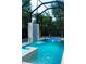 Screened in pool area with hot tub and custom rock waterfall feature at 2375 Floyd St, Sarasota, FL 34239