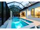 Screened in pool area with hot tub, waterfall feature, outdoor bar and outdoor kitchen at 2375 Floyd St, Sarasota, FL 34239