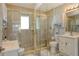 Bathroom featuring a tile shower, vanity with sink, and mirrored cabinets at 2752 Riverbluff Pl # 66, Sarasota, FL 34231