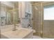 Bathroom vanity featuring a sink, toilet, and built-in shelving within glass-enclosed shower at 2752 Riverbluff Pl # 66, Sarasota, FL 34231