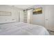 Bright bedroom with a slider door, wall-mounted TV, and easy access to the en-suite bathroom at 2752 Riverbluff Pl # 66, Sarasota, FL 34231