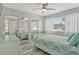 Bright bedroom featuring coastal decor, ceiling fan, and a mirrored closet, creating a relaxing atmosphere at 2752 Riverbluff Pl # 66, Sarasota, FL 34231