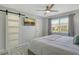 Serene bedroom with a sliding door, ceiling fan, and a wall-mounted TV for entertainment at 2752 Riverbluff Pl # 66, Sarasota, FL 34231