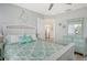Cozy bedroom with coastal accents, white furniture, and a view into the kitchen at 2752 Riverbluff Pl # 66, Sarasota, FL 34231