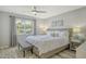 Relaxing bedroom with a ceiling fan, a plush bed, and a large window with neighborhood views at 2752 Riverbluff Pl # 66, Sarasota, FL 34231