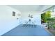 Covered carport with a table and chairs, providing a cozy outdoor seating area at 2752 Riverbluff Pl # 66, Sarasota, FL 34231