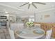 Bright dining area with a round table, a full place setting, and an open concept at 2752 Riverbluff Pl # 66, Sarasota, FL 34231
