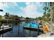 Scenic view of a canal lined with private boat docks and lush palm trees at 2752 Riverbluff Pl # 66, Sarasota, FL 34231