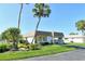 Charming single-story home with tropical landscaping and a covered carport area at 2752 Riverbluff Pl # 66, Sarasota, FL 34231