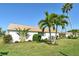 Well-maintained home with lush green lawn, complemented by beautiful landscaping and swaying palm trees at 2752 Riverbluff Pl # 66, Sarasota, FL 34231