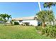 Well-maintained home exterior with lush lawn and tropical landscaping on a sunny day at 2752 Riverbluff Pl # 66, Sarasota, FL 34231