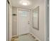 Welcoming entryway with decorative mirror and adjacent closet at 2752 Riverbluff Pl # 66, Sarasota, FL 34231