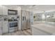 Beautiful kitchen and living room with stainless appliances, white cabinets, and coastal décor at 2752 Riverbluff Pl # 66, Sarasota, FL 34231