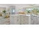 Bright open kitchen and dining area featuring an island with quartz countertops at 2752 Riverbluff Pl # 66, Sarasota, FL 34231