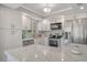Bright kitchen featuring white cabinets, granite countertops, stainless steel appliances, and stylish lighting at 2752 Riverbluff Pl # 66, Sarasota, FL 34231