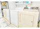Functional laundry room features both a washer and dryer with convenient shelving for storage at 2752 Riverbluff Pl # 66, Sarasota, FL 34231