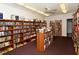 Community library with rows of bookshelves filled with books under a ceiling fan and fluorescent lights at 2752 Riverbluff Pl # 66, Sarasota, FL 34231