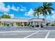 Parking lot with landscaping leading to the building entrance under a bright, sunny sky at 2752 Riverbluff Pl # 66, Sarasota, FL 34231