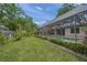 Lush backyard with a screened pool area, mature trees, and well-maintained landscaping at 2815 Mayflower St, Sarasota, FL 34231