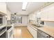 Traditional kitchen with double basin sink and stainless steel dishwasher overlooks breakfast nook at 2815 Mayflower St, Sarasota, FL 34231