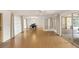 Bright living room features wood floors, dining area, and sliding glass doors to a lanai offering seamless indoor-outdoor living at 2815 Mayflower St, Sarasota, FL 34231