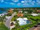 Residential neighborhood home with lush green landscaping and a screened in pool at 284 Lookout Point Dr, Osprey, FL 34229
