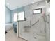 Bright bathroom featuring walk-in shower, with white tile, a bench and a stand alone tub at 284 Lookout Point Dr, Osprey, FL 34229