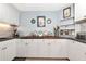 Bright kitchen with white cabinets, granite countertops, a wood-topped island, and stainless-steel appliances at 284 Lookout Point Dr, Osprey, FL 34229