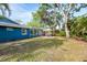 Landscaped backyard featuring a patio, mature trees, and an inviting outdoor space at 2933 Mayflower St, Sarasota, FL 34231