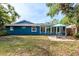 Spacious backyard featuring a patio area with outdoor seating and lush green grass at 2933 Mayflower St, Sarasota, FL 34231