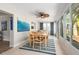 Bright sunroom with large windows, dining table and chairs, ceiling fan, and tropical decor at 2933 Mayflower St, Sarasota, FL 34231