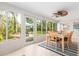Light-filled dining room with large windows overlooking the backyard, showcasing a charming table and chairs set for a meal at 2933 Mayflower St, Sarasota, FL 34231