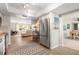 Bright kitchen with stainless steel refrigerator, wood-look floors and open access to the living and dining areas at 2933 Mayflower St, Sarasota, FL 34231