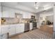 Well-appointed kitchen featuring stainless steel appliances, white cabinets, mosaic backsplash, and ample counter space at 2933 Mayflower St, Sarasota, FL 34231