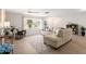 Bright living room with wood-look floors, a large window, and neutral furniture at 2933 Mayflower St, Sarasota, FL 34231