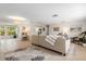 Bright, open living room with tile floors, neutral tones, and a comfortable seating area, seamlessly flowing into the kitchen at 2933 Mayflower St, Sarasota, FL 34231