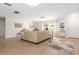 Spacious living room featuring light wood-look flooring, ample natural light, and stylish decor, creating a welcoming atmosphere at 2933 Mayflower St, Sarasota, FL 34231