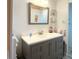 Bathroom featuring a gray vanity with a white countertop, a framed mirror, and a decorative flamingo accent at 3414 Spanish Oak Ter, Sarasota, FL 34237