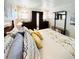 Bright bedroom features a comfortable queen bed with decorative pillows, a dark wood armoire and a window at 3414 Spanish Oak Ter, Sarasota, FL 34237
