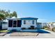 Charming mobile home featuring a screened-in porch, manicured landscaping, and a welcoming exterior at 3414 Spanish Oak Ter, Sarasota, FL 34237