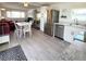 Open kitchen and dining area with stainless steel appliances and modern countertops at 3414 Spanish Oak Ter, Sarasota, FL 34237