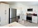 Bright kitchen boasts stainless steel appliances and white cabinets with modern hardware at 3414 Spanish Oak Ter, Sarasota, FL 34237