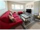 Bright living room showcasing a stylish sofa, geometric rug, and a large bay window at 3414 Spanish Oak Ter, Sarasota, FL 34237
