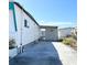 Clean mobile home exterior with an attached carport and well-manicured garden, offering privacy at 3414 Spanish Oak Ter, Sarasota, FL 34237