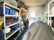 Utility room equipped with washer, dryer, storage shelves and water heater for added convenience at 3414 Spanish Oak Ter, Sarasota, FL 34237