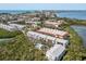 Aerial view of complex showing community pool, landscaping, and Intracoastal at 3601 East Bay Dr # 205, Holmes Beach, FL 34217