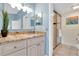Bathroom vanity with granite counters and a glass shower door at 3601 East Bay Dr # 205, Holmes Beach, FL 34217