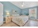 Light-filled bedroom with pale blue walls, coastal décor and tiled floors at 3601 East Bay Dr # 205, Holmes Beach, FL 34217