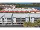 Exterior view of complex with multiple units and large balconies overlooking the pond at 3601 East Bay Dr # 205, Holmes Beach, FL 34217